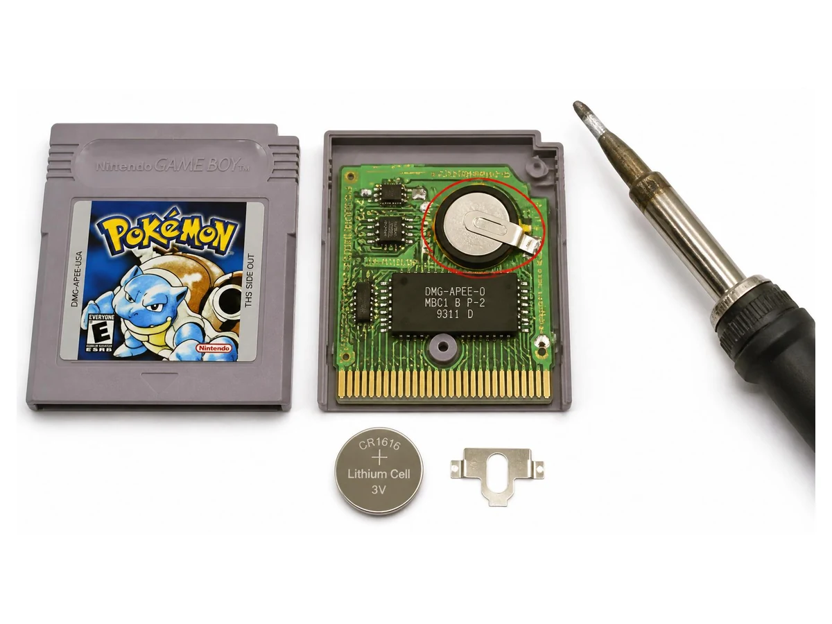 Open Game Boy cartridge with the save battery and soldering tools visible